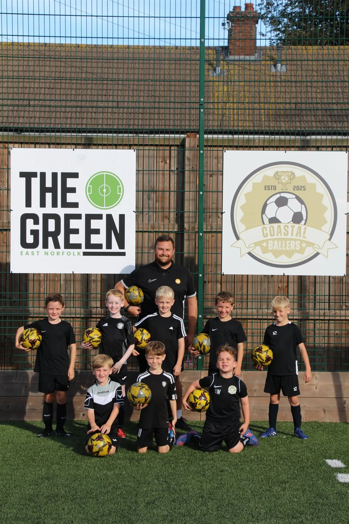 Young Coastal Ballers players and their coach at The Green